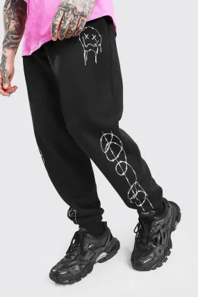 Loose Fit Barbed Wire Drip Face Joggers | boohooMAN UK